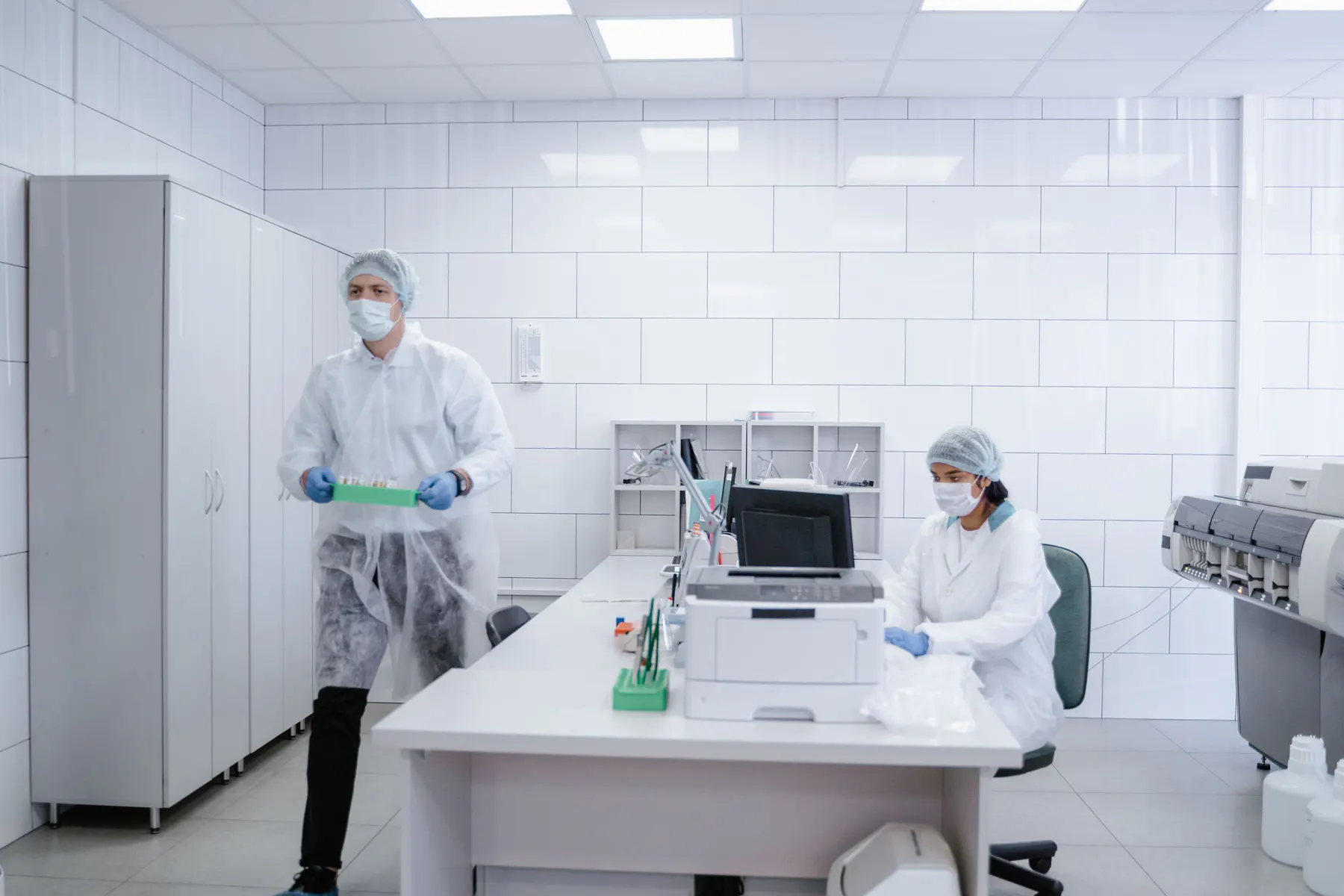 Technical team working inside a bright controlled laboratory