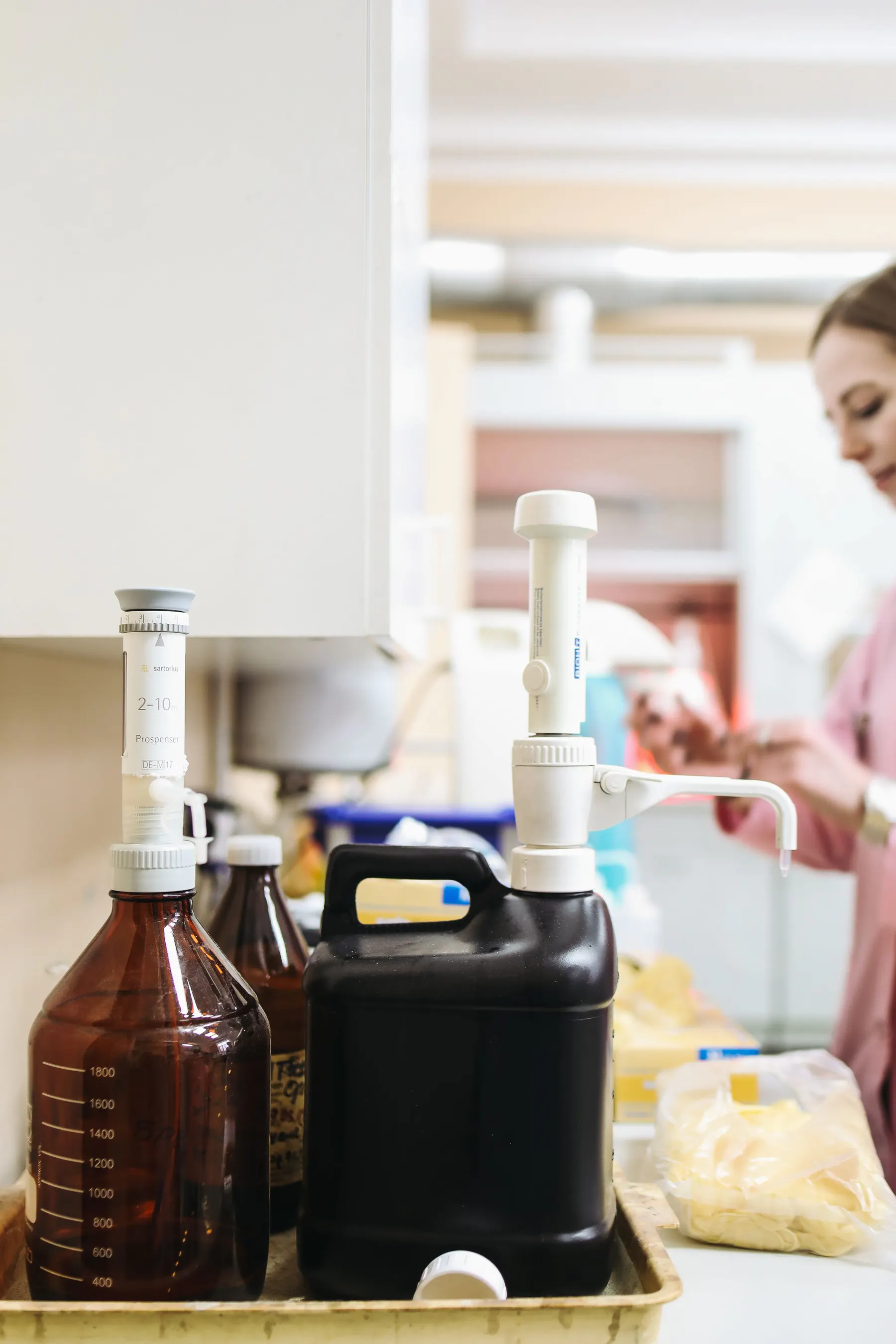 Technical specialist preparing measured materials at a laboratory bench